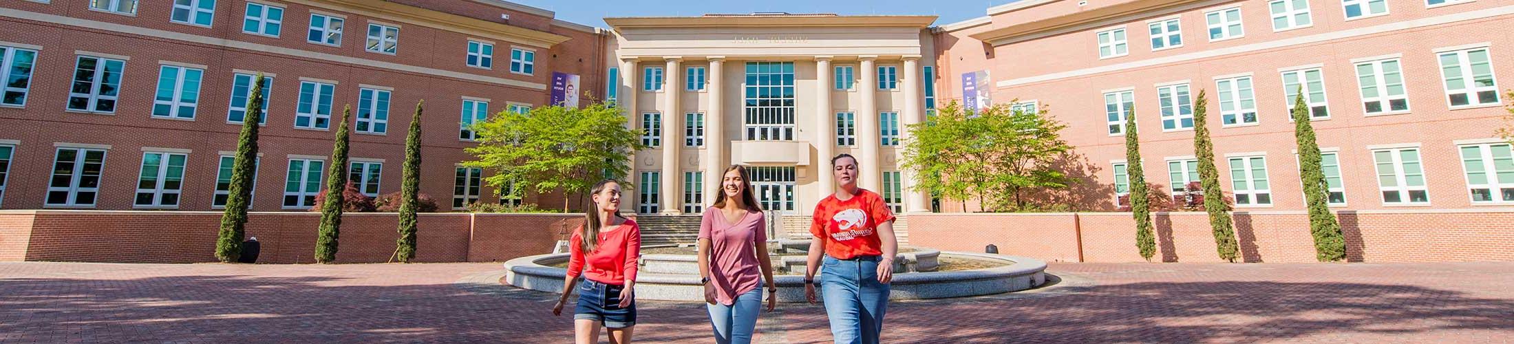 Three students walking in front of Shelby Hall.